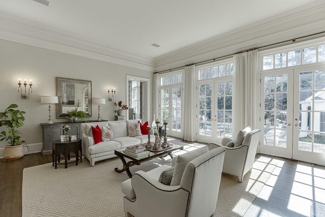 living area with a healthy amount of sunlight, crown molding, and french doors