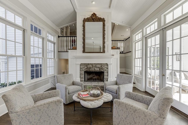 living room featuring lofted ceiling, a fireplace, baseboards, and dark wood-type flooring