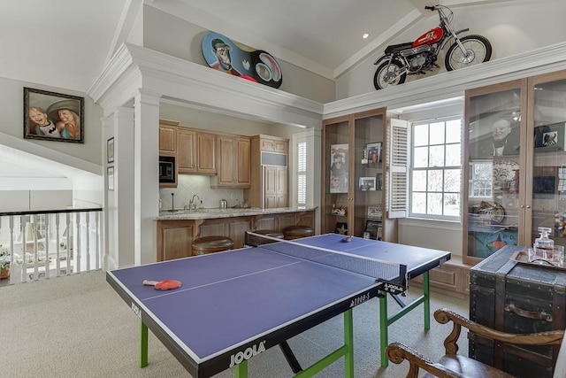 playroom with carpet floors, high vaulted ceiling, and a sink