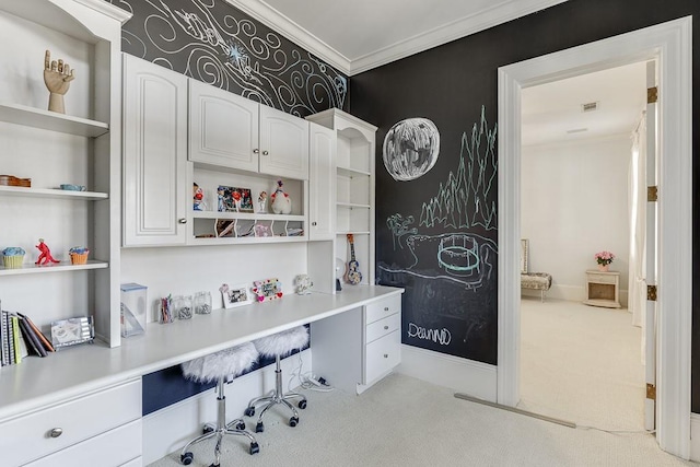 office with baseboards, built in desk, carpet flooring, and crown molding