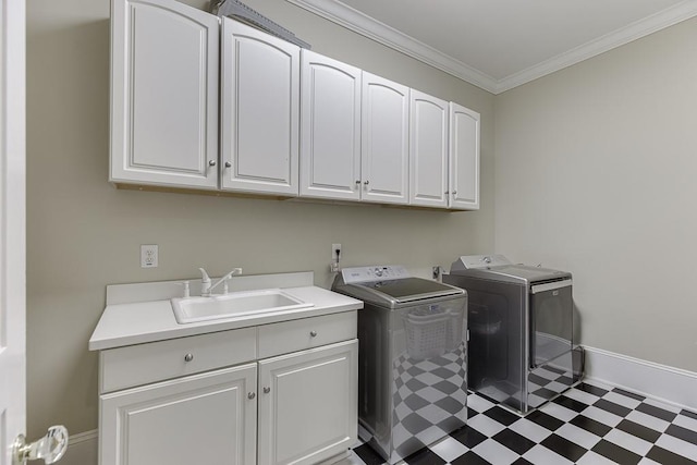 laundry area with cabinet space, ornamental molding, a sink, independent washer and dryer, and tile patterned floors