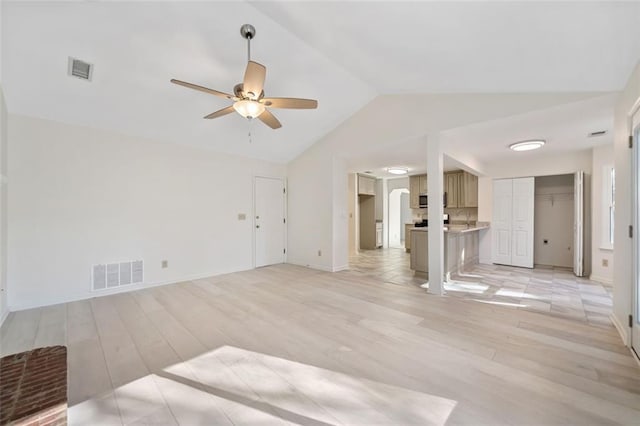 living room featuring vaulted ceiling, ceiling fan, and light hardwood / wood-style flooring