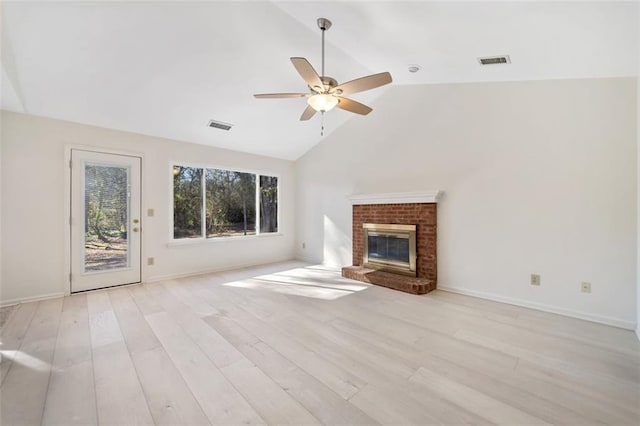 unfurnished living room with light wood-type flooring, ceiling fan, a brick fireplace, and lofted ceiling