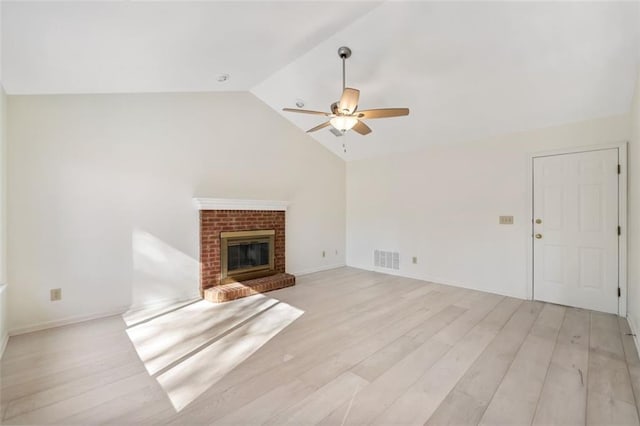 unfurnished living room with light wood-type flooring, ceiling fan, a fireplace, and lofted ceiling