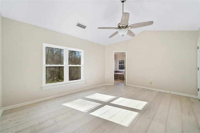 unfurnished room featuring ceiling fan, light hardwood / wood-style flooring, and lofted ceiling