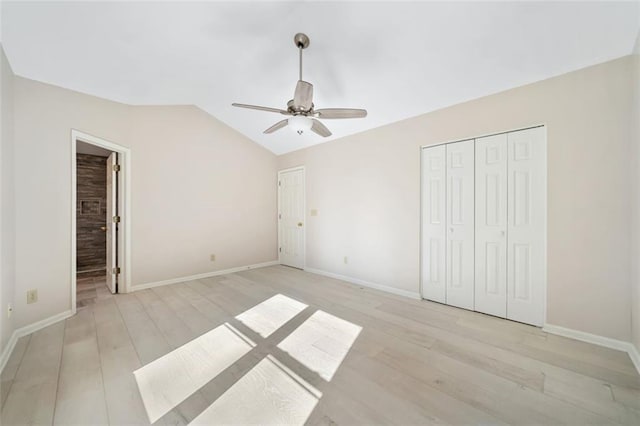 unfurnished bedroom featuring light wood-type flooring, vaulted ceiling, and ceiling fan