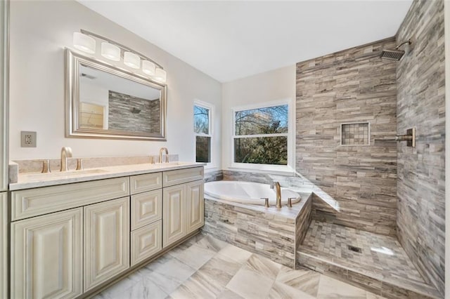 bathroom featuring vanity and tiled bath