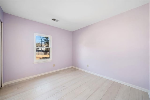 spare room with light hardwood / wood-style flooring