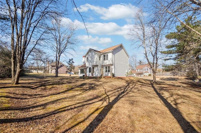 view of side of property with a yard