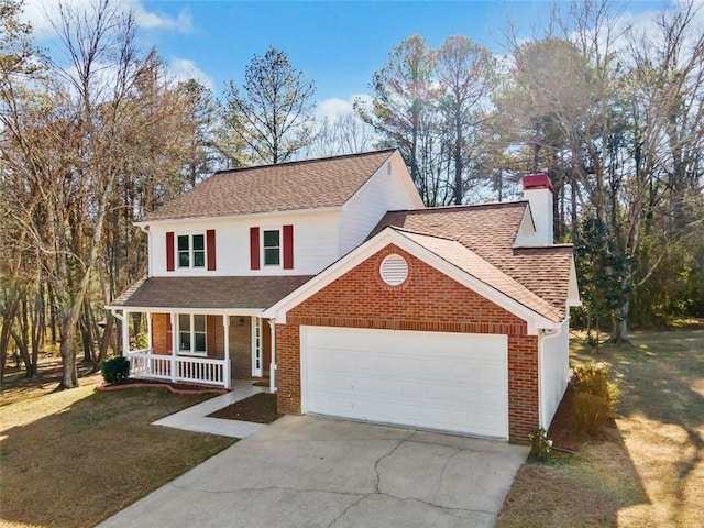 view of front of home featuring covered porch, a front yard, and a garage