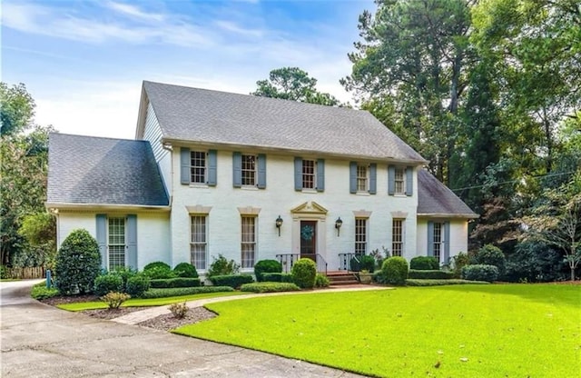 colonial home with a front lawn