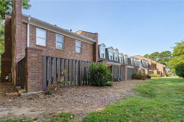 view of property exterior featuring a lawn