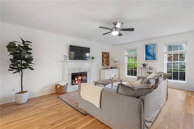 living room with ceiling fan, light hardwood / wood-style flooring, and a healthy amount of sunlight