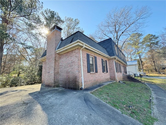 view of property exterior with a lawn