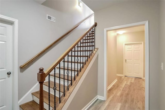 stairway with hardwood / wood-style flooring