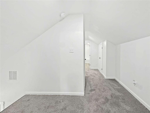 bonus room featuring visible vents, baseboards, lofted ceiling, and carpet floors
