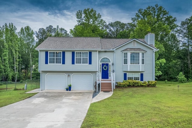 split foyer home featuring driveway, an attached garage, and a chimney