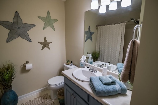 bathroom featuring toilet, vanity, curtained shower, baseboards, and a chandelier