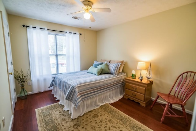 bedroom with wood finished floors, baseboards, and a ceiling fan