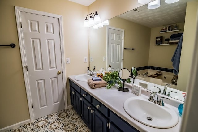 bathroom featuring double vanity, baseboards, a garden tub, and a textured ceiling