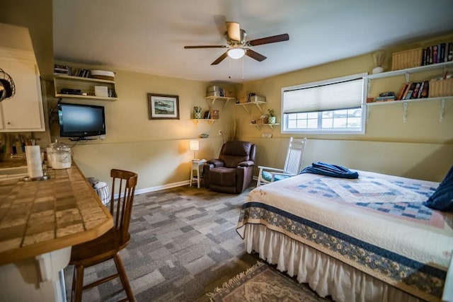 carpeted bedroom with baseboards and ceiling fan