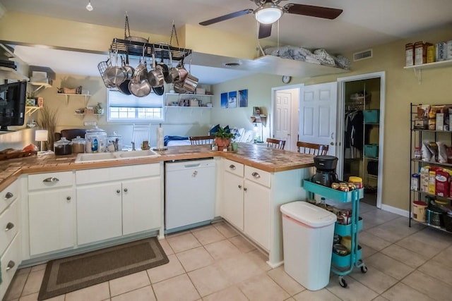 kitchen with dishwasher, a sink, ceiling fan, and light tile patterned flooring