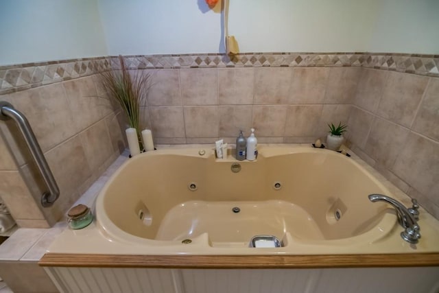 bathroom with a tub with jets