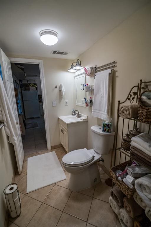 bathroom with tile patterned flooring, toilet, and vanity