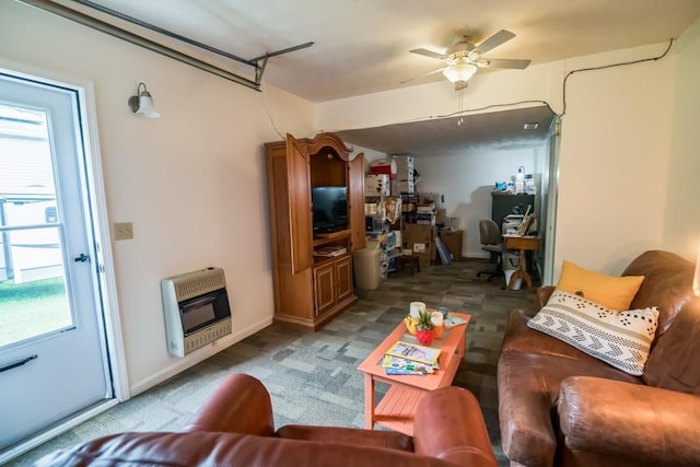 living room with heating unit, healthy amount of natural light, a ceiling fan, and carpet