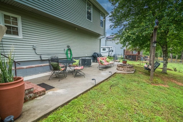 view of patio / terrace featuring central AC unit and a fire pit