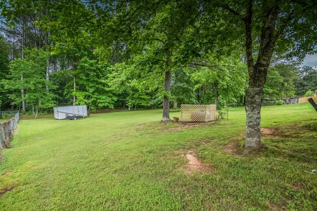 view of yard featuring an outbuilding and a storage unit