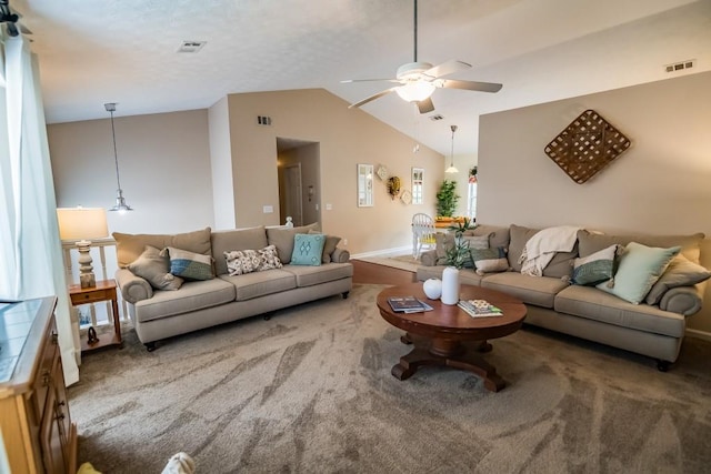 living area featuring ceiling fan, lofted ceiling, and carpet