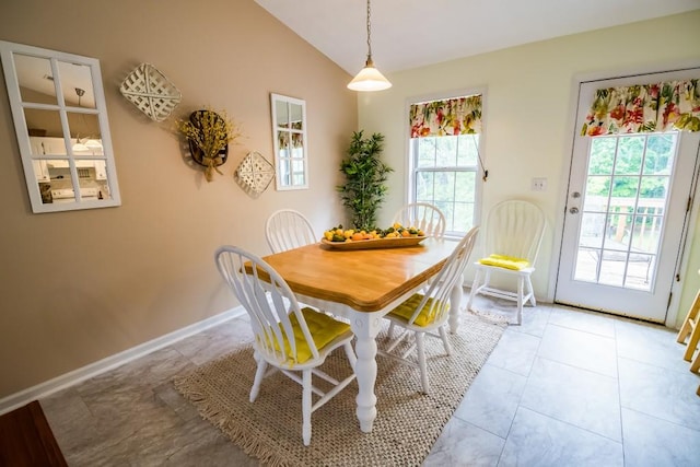 dining space with lofted ceiling and baseboards