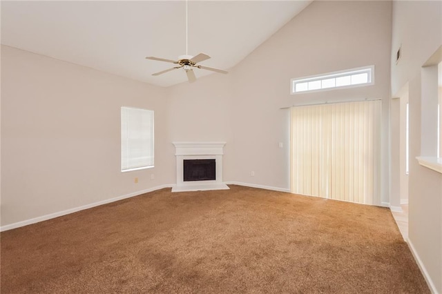 unfurnished living room featuring carpet, baseboards, high vaulted ceiling, a fireplace, and ceiling fan