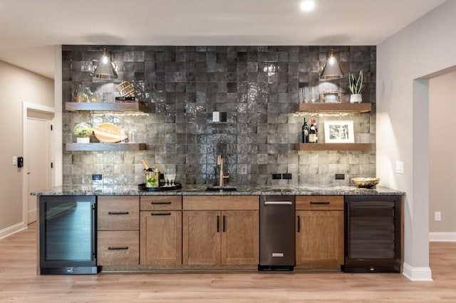 bar featuring beverage cooler, wet bar, and tasteful backsplash