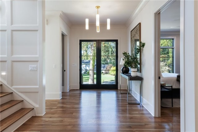 doorway to outside with baseboards, stairs, ornamental molding, and wood finished floors