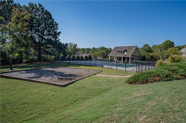 exterior space with a lawn and a swimming pool