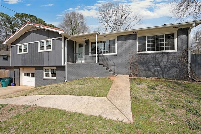 view of front of house with a garage, brick siding, concrete driveway, and a front lawn