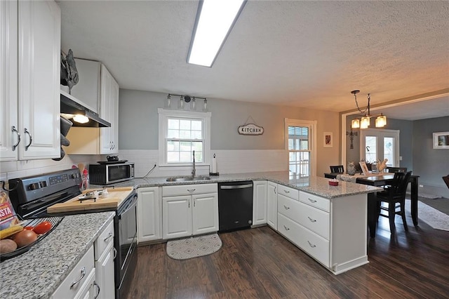 kitchen featuring a sink, stainless steel microwave, electric range oven, dishwasher, and dark wood-style flooring