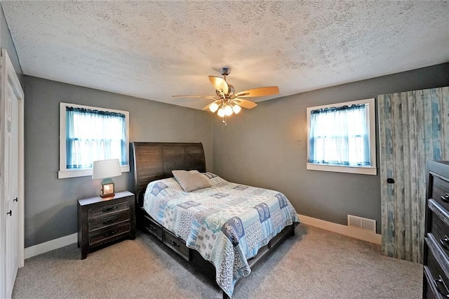 bedroom with multiple windows, light colored carpet, and visible vents