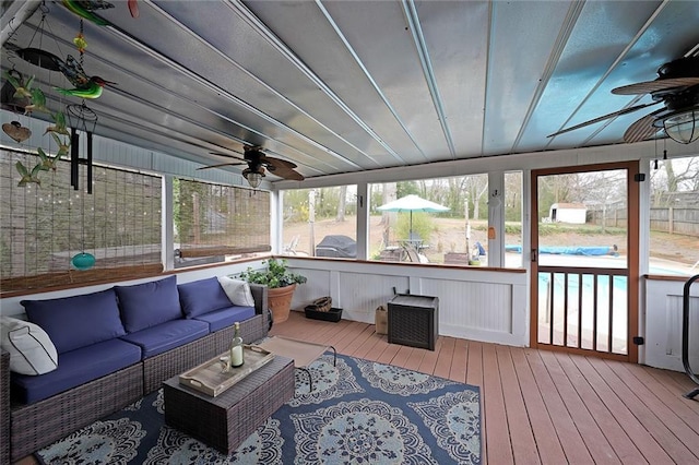 sunroom featuring a healthy amount of sunlight and a ceiling fan