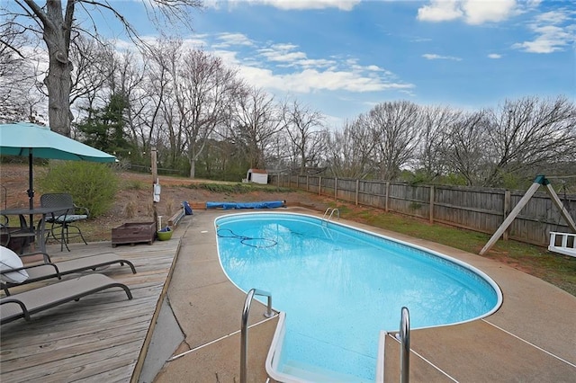 view of pool with a deck, a fenced in pool, and a fenced backyard