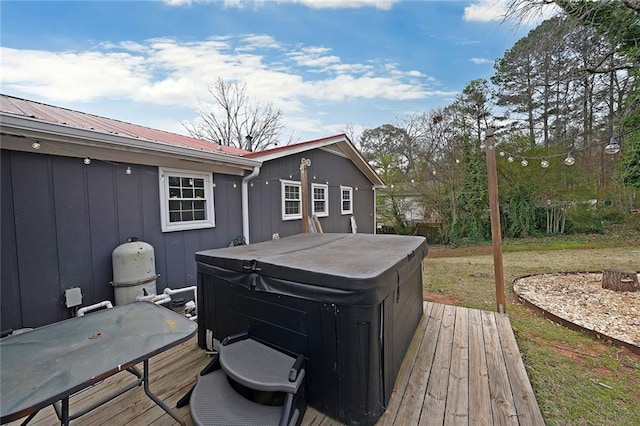 wooden deck with a hot tub