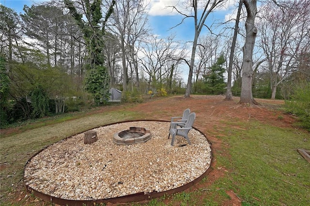 view of yard featuring an outdoor fire pit