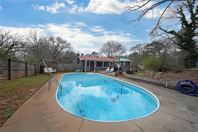 view of swimming pool featuring a fenced in pool, a patio, and a fenced backyard