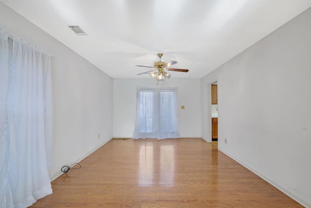 spare room with light hardwood / wood-style flooring and ceiling fan