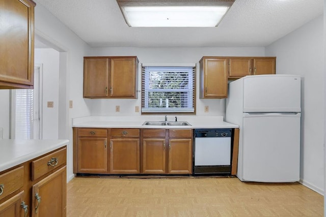 kitchen featuring sink, a textured ceiling, and white appliances