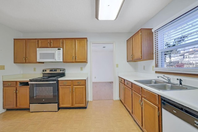 kitchen featuring sink and white appliances