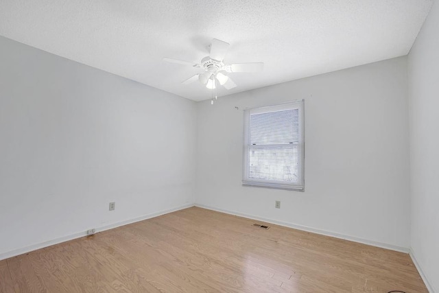 spare room featuring ceiling fan and light wood-type flooring