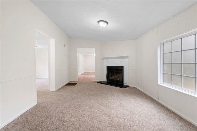 unfurnished living room with light colored carpet